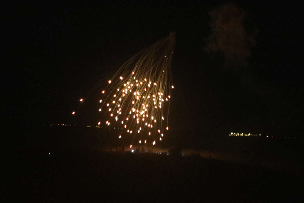 An Israeli strike illuminates the sky above the southern Lebanese village of Khiam late on April 17, 2024, amid ongoing cross-border tensions as fighting continues between Israel and Hamas militants in the Gaza Strip.