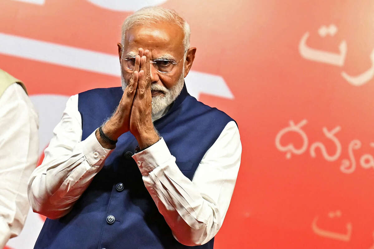 India's Prime Minister Narendra Modi gestures at the Bharatiya Janata Party (BJP) headquarters to celebrate the party's win in country's general election, in New Delhi on June 4, 2024.