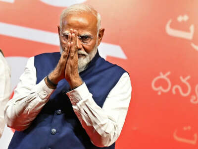 India's Prime Minister Narendra Modi gestures at the Bharatiya Janata Party (BJP) headquarters to celebrate the party's win in country's general election, in New Delhi on June 4, 2024.