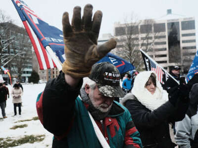 Supporters of President Donald Trump join in a mass prayer out front of the Michigan State Capitol Building to protest the certification of Joe Biden as the next president on January 6, 2021, in Lansing, Michigan.