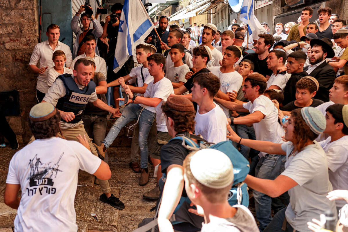 Israeli right-wing activists scuffle with Palestinian freelance journalist Saif Kwasmi on June 5, 2024, during the so-called Jerusalem Day flag march.