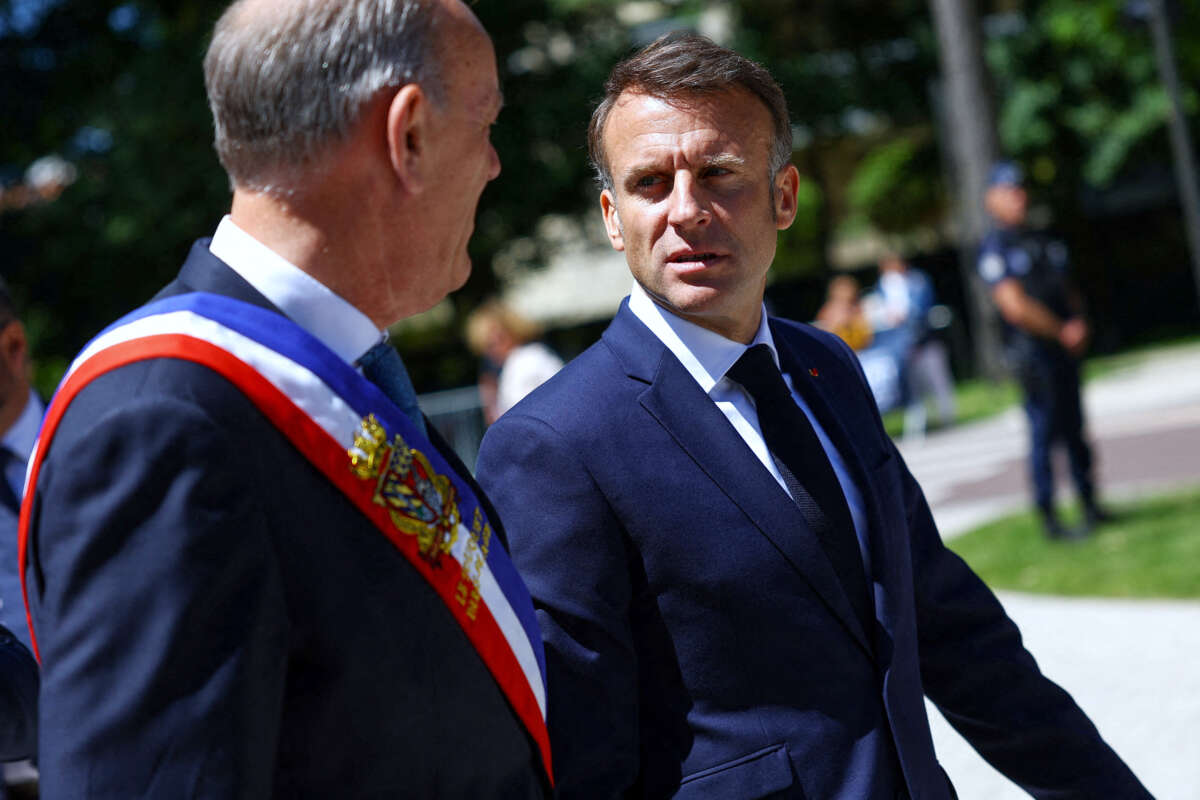 France's President Emmanuel Macron (R) walks with Daniel Fasquelle (L)