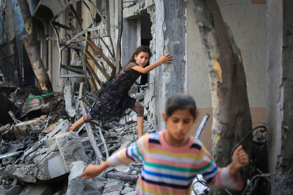 A Palestinian girl climbs over debris a day after an operation by the Israeli Special Forces in the Nuseirat camp, in the central Gaza Strip on June 9, 2024.