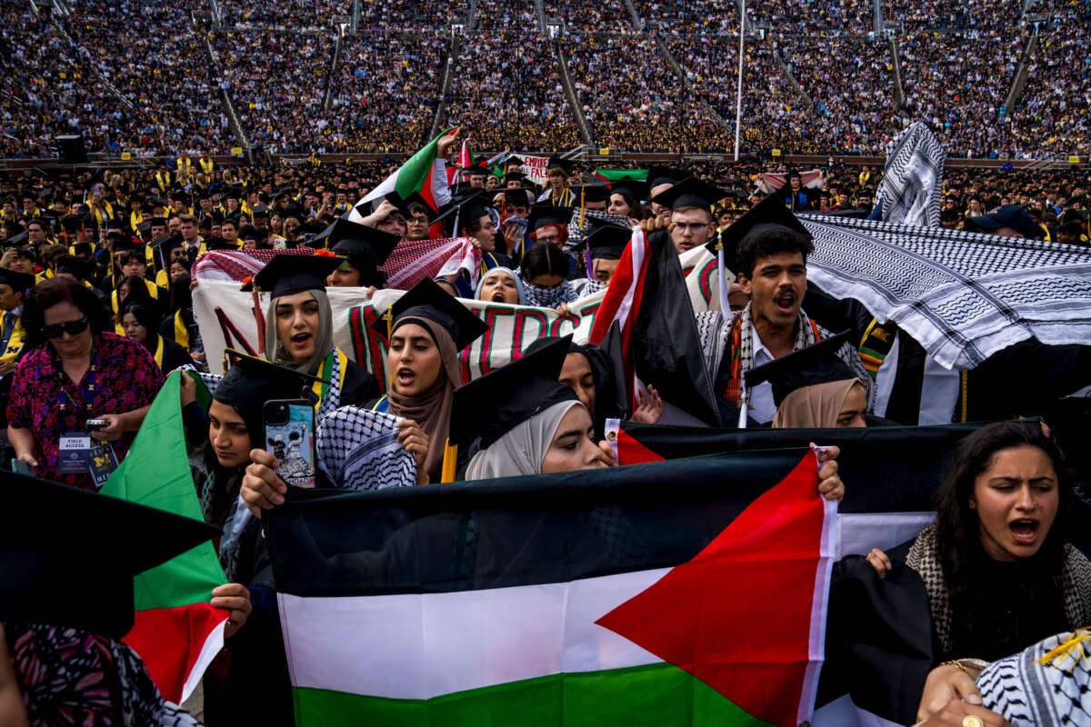 Students demonstrate during a pro-Palestinian protest during the University of Michigan's spring commencement ceremony on May 4, 2024, at Michigan Stadium in Ann Arbor, Michigan.