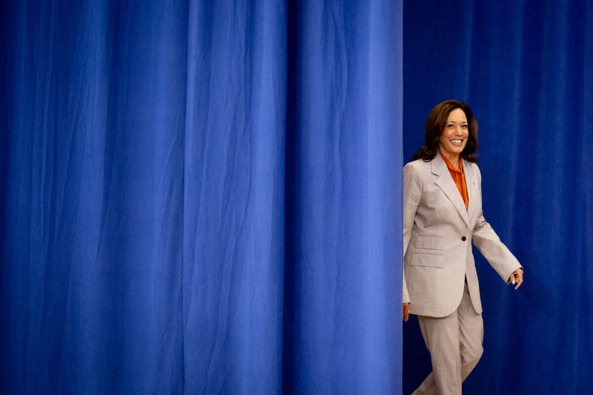 Kamala Harris steps out from behind a curtain
