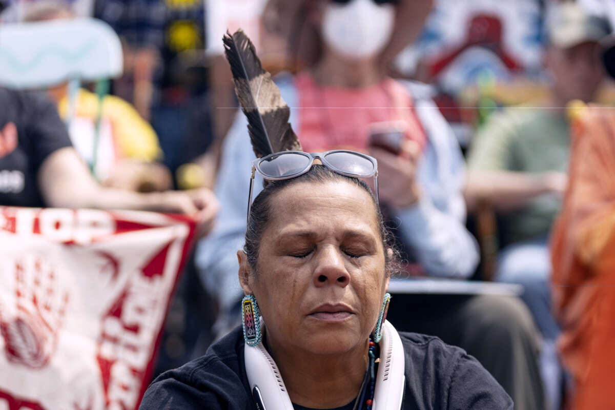 An Indigenous person cries during an outdoor demonstration