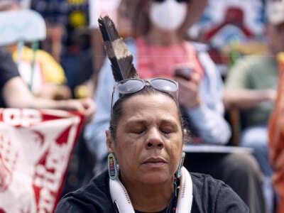 An Indigenous person cries during an outdoor demonstration