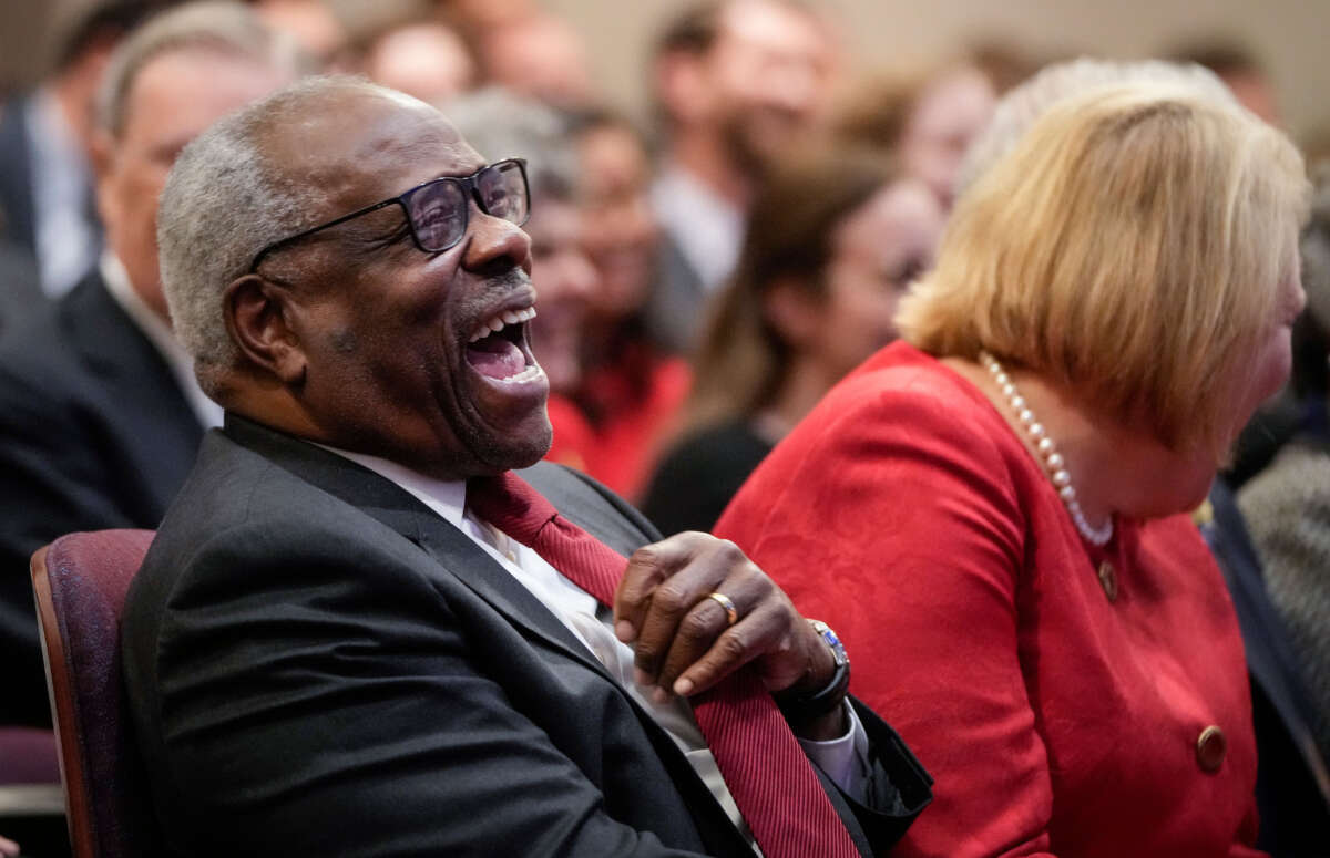 Associate Supreme Court Justice Clarence Thomas sits with his wife and conservative activist Virginia Thomas while he waits to speak at the Heritage Foundation on October 21, 2021, in Washington, D.C.