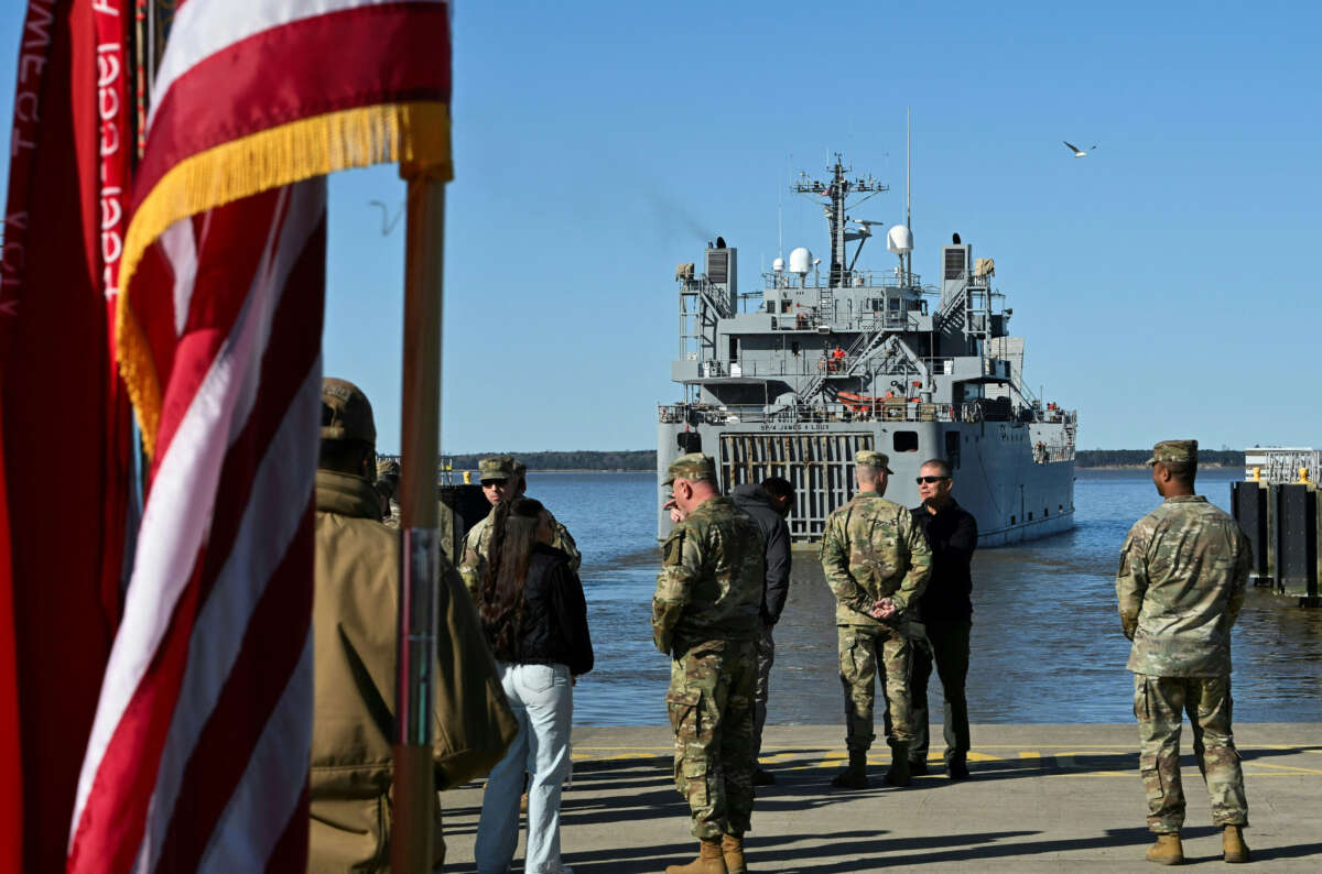 U.S. soldiers stand on the pier as the USAV SP4 James A. Loux casts off from Joint Base Langley-Eustis during a media preview of the 7th Transportation Brigade deployment in Hampton, Virginia, on March 12, 2024.