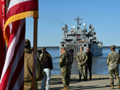 U.S. soldiers stand on the pier as the USAV SP4 James A. Loux casts off from Joint Base Langley-Eustis during a media preview of the 7th Transportation Brigade deployment in Hampton, Virginia, on March 12, 2024.