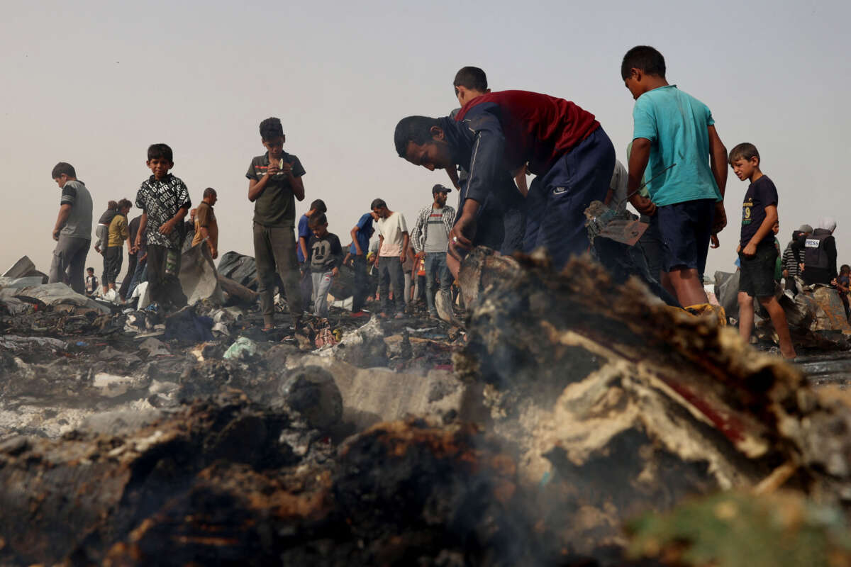 Palestinians gather at the site of an Israeli strike on a camp for internally displaced people in Rafah on May 27, 2024.