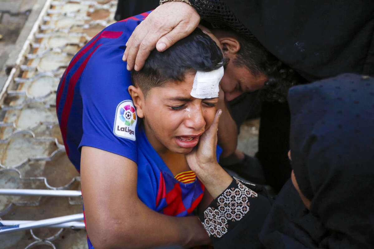 Relatives of the Palestinians who died after an Israeli strike hit the Nuseirat refugee camp mourn at the morgue of the Al Aqsa Martyrs Hospital in Deir Al Balah, Gaza, on June 18, 2024.