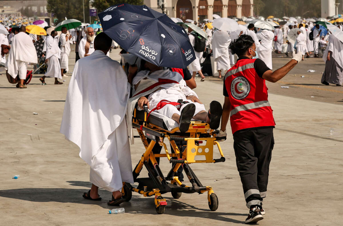 Medical team members evacuate a Muslim pilgrim, affected by the scorching heat, at the base of Mount Arafat, also known as Jabal al-Rahma or Mount of Mercy, during the annual Hajj pilgrimage on June 15, 2024.