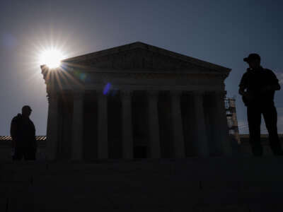 Police officers stand guard as the sun rises over the Supreme Court on June 21, 2024, in Washington, D.C.