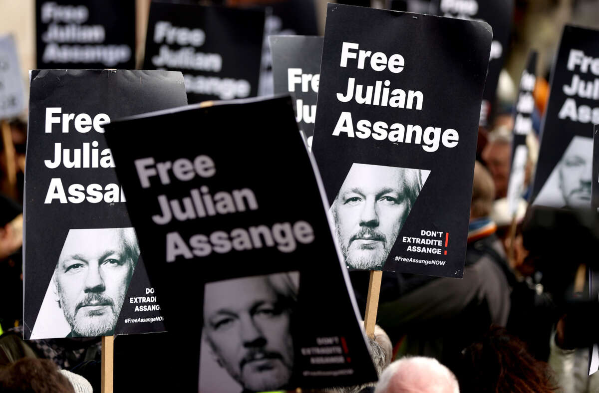 Signs showing support for WikiLeaks founder Julian Assange are seen in a protest outside the High Court in London, Britain, on March 26, 2024.