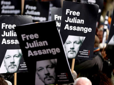 Signs showing support for WikiLeaks founder Julian Assange are seen in a protest outside the High Court in London, Britain, on March 26, 2024.