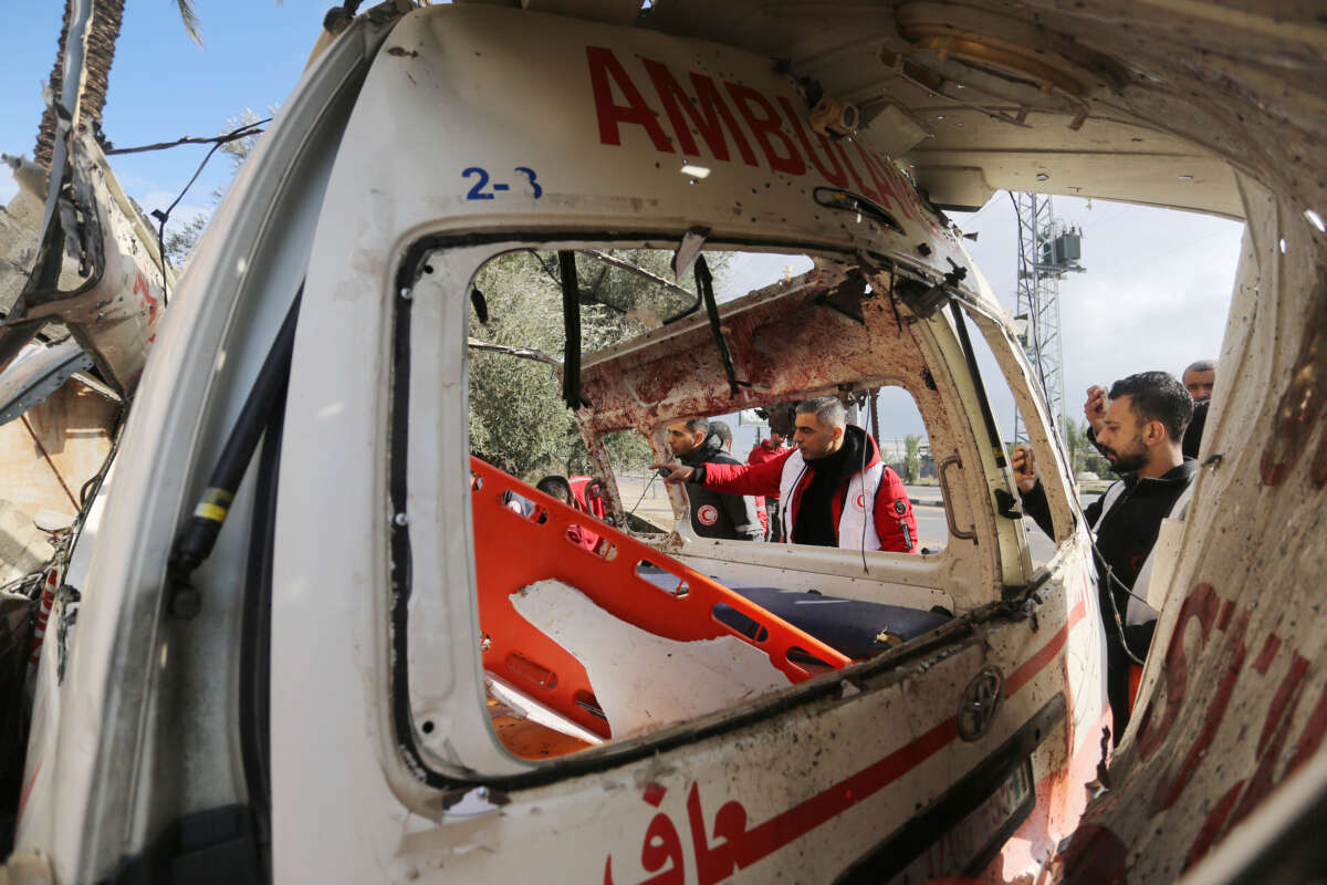 Medical personnel inspect the wreckage of an ambulance after the Israeli army's attack in Deir al-Balah, Gaza, on January 11, 2024.