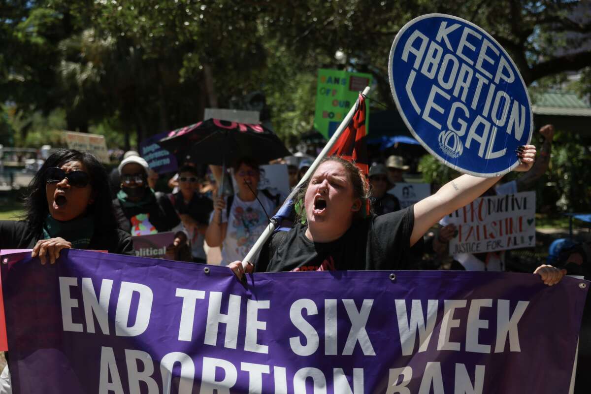 Demonstrators walk together during a “Rally to Stop the Six-Week Abortion Ban” held at Lake Eola Park on April 13, 2024, in Orlando, Florida. Iowa's Supreme Court upheld a similar ban on June 28, 2024.