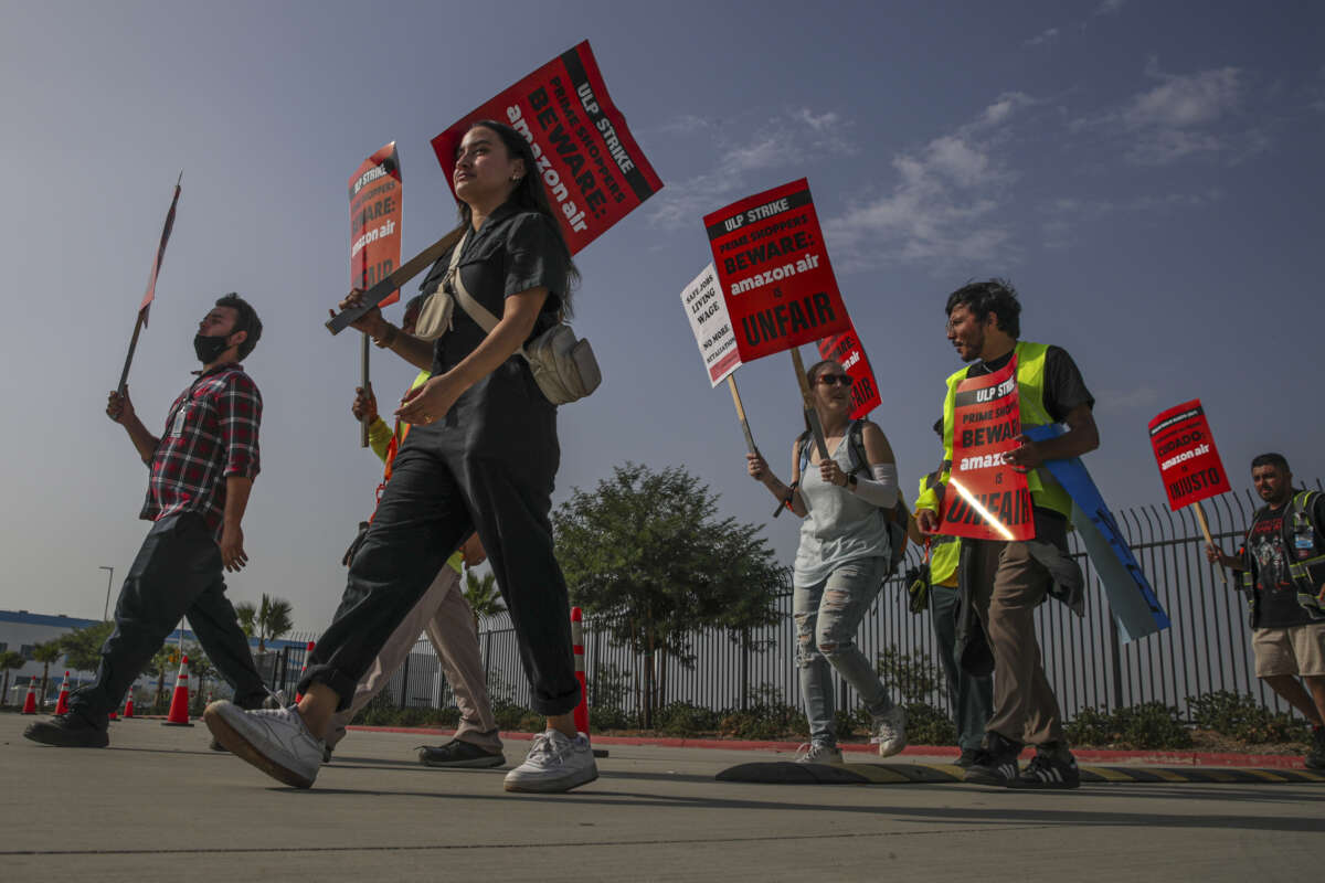 Amazon warehouse workers and members of Teamsters Union protest Amazons unfair labor practices and shameful response to workers demands for better, safer jobs with fair wages and an end to retaliation at Amazon Air Hub on October 14, 2022, in San Bernardino, California.