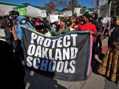 Students, teachers and parents walked out of Westlake Middle School and marched to Oakland Unified School District offices to protest its consideration for closure by the district in Oakland, California, on February 1, 2022.