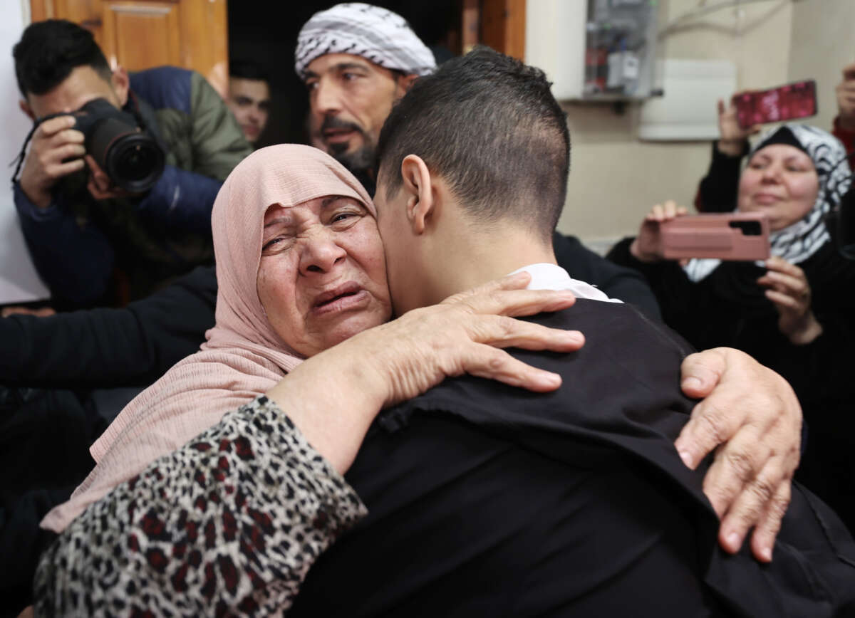 14 year-old Palestinian Ahmed Nawaf Al-Salayma, released from Israeli jail as part of the prisoners swap deal between Israel and Hamas, reunites with his family in Jerusalem, on November 28, 2023.