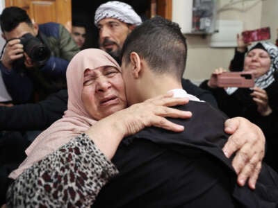 14 year-old Palestinian Ahmed Nawaf Al-Salayma, released from Israeli jail as part of the prisoners swap deal between Israel and Hamas, reunites with his family in Jerusalem, on November 28, 2023.