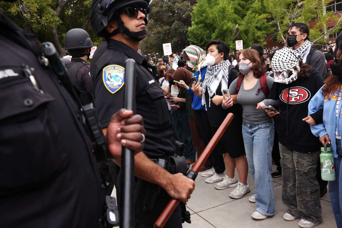 UCLA protestors lock arms as police move in as students try to build a new Palestinian solidarity encampment on campus on May 23, 2024, in Los Angeles, California.