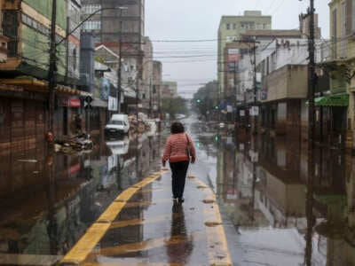 A woman walks through a flooded street in Porto Alegre, Rio Grande do Sul State, Brazil, on May 24, 2024.