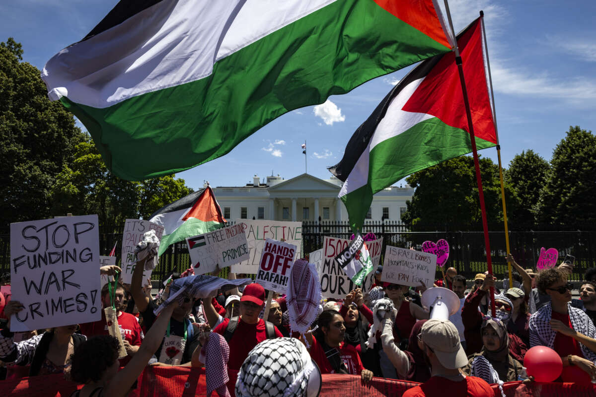 Protesters wave Palestinian flags and chant on Pennsylvania Avenue in front of the White House during a demonstration against the genocide in Gaza on June 8, 2024, in Washington, D.C.