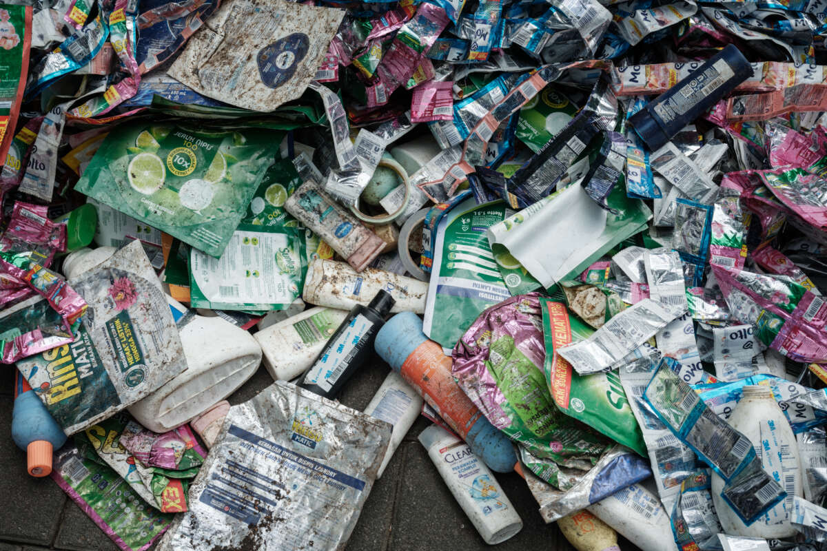 Members of Greenpeace Indonesia display plastic waste from British multinational hygiene and food giant Unilever's products as part of their "Return to Sender" action in front of Unilever's office in Tangerang, a suburb of Jakarta, on June 20, 2024.
