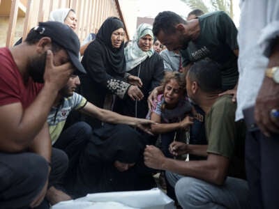 Displaced Palestinians mourn during a funeral ceremony for their relatives after Israeli airstrikes killed 25 and injured 50 people at Al-Nasr Hospital in al-Mawasi neighborhood of Rafah, Gaza, on June 21, 2024.