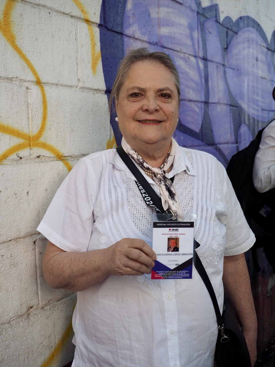 Colombian Senator Clara López Obregón shows her official credential from Mexico's electoral authority before proceeding to the first stop on her election observation mission in Mexico City on June 2, 2024.