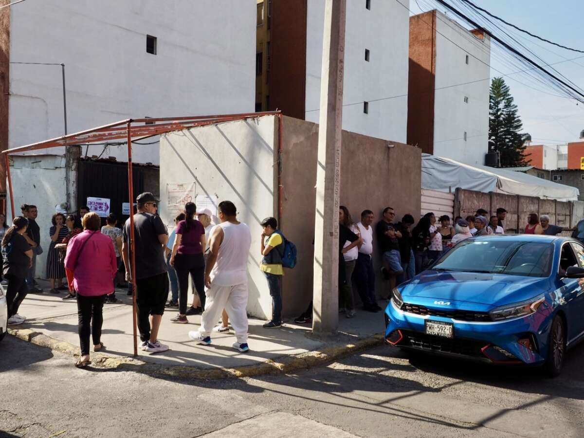 A line that snakes around the building is seen before the opening of a polling location in the Gustavo A. Madero borough of Mexico City on June 2, 2024.