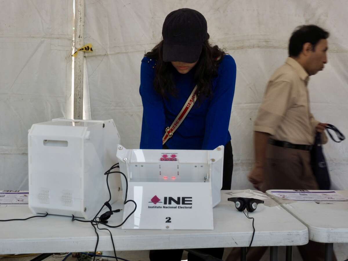 A voter casts her ballot using an electronic voting machine at one of the special polling locations in Mexico City for citizens who find themselves outside their voting location on election day, June 2, 2024.