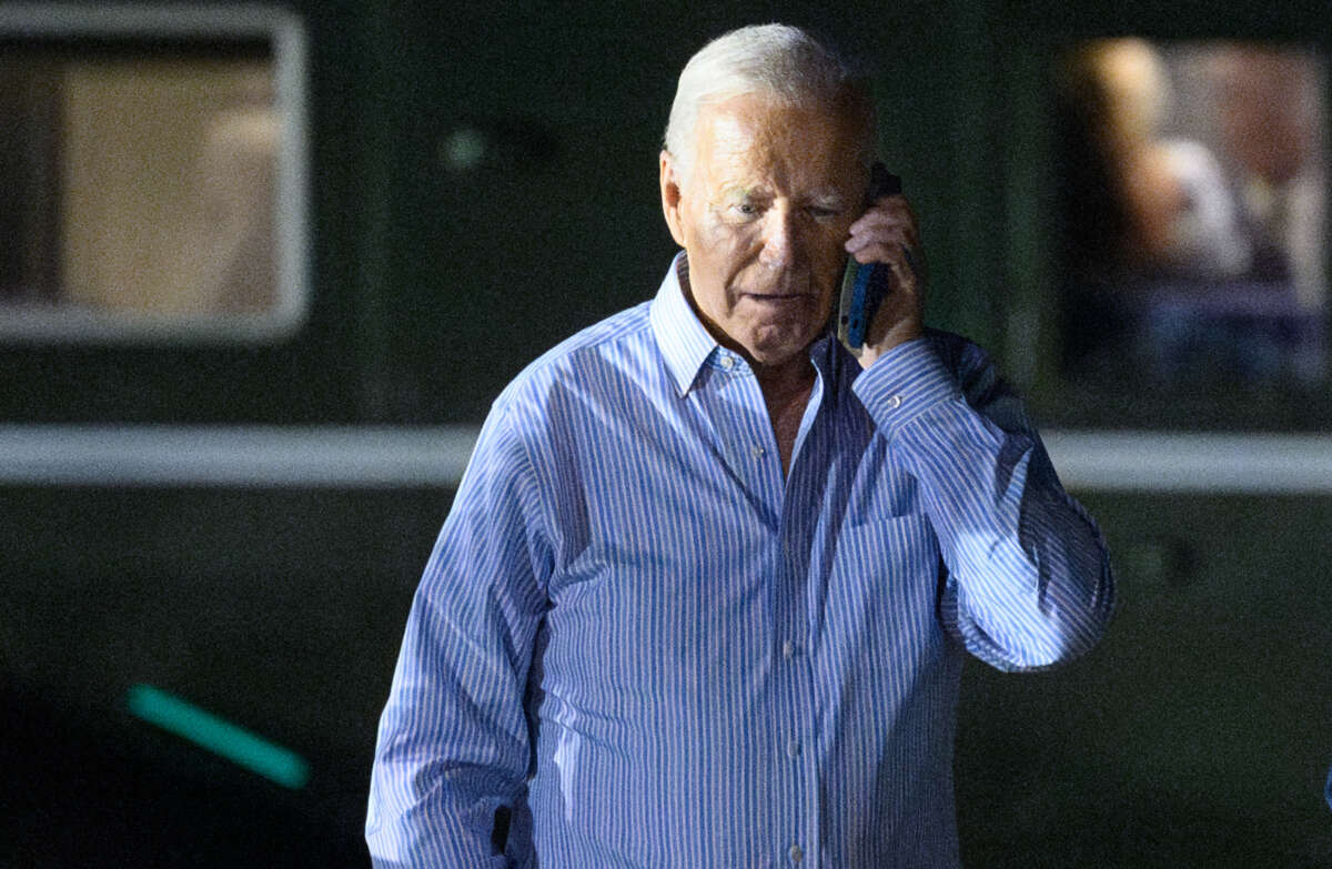 President Joe Biden speaks on the phone while walking from Marine One to board Air Force One before departing McGuire Air Force Base in New Jersey on June 29, 2024.