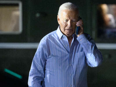 President Joe Biden speaks on the phone while walking from Marine One to board Air Force One before departing McGuire Air Force Base in New Jersey on June 29, 2024.