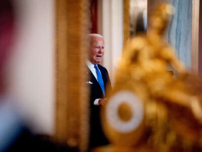 President Joe Biden, seen in reflection, speaks to the media at the White House on July 1, 2024, in Washington, DC.