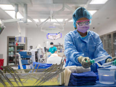 A medical worker prepares medical equipment for surgery