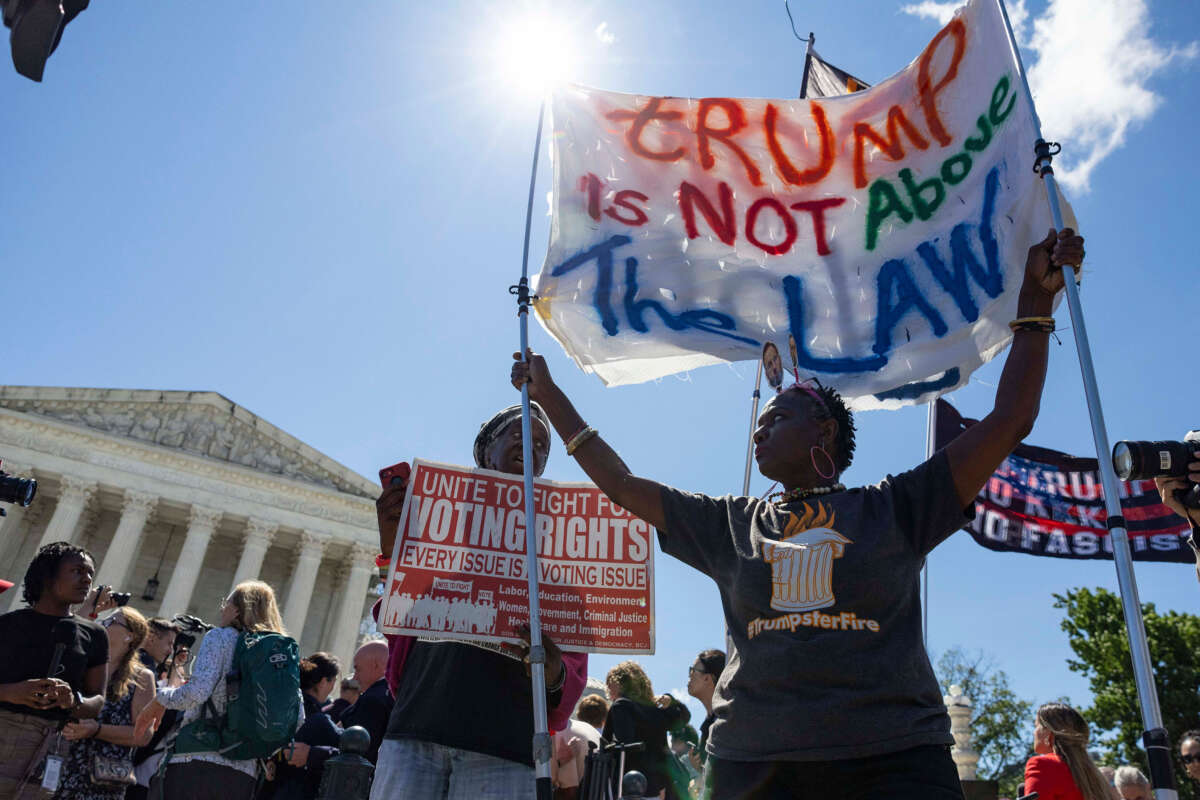 Protesters hold up signs outside of the Supreme Court of the United States in Washington, D.C. on July 1, 2024.