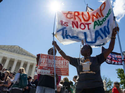 Protesters hold up signs outside of the Supreme Court of the United States in Washington, D.C. on July 1, 2024.