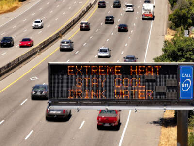 In an aerial view, a Caltrans changeable message sign on Highway 101 displays a warning about extreme heat on July 2, 2024, in Corte Madera, California.
