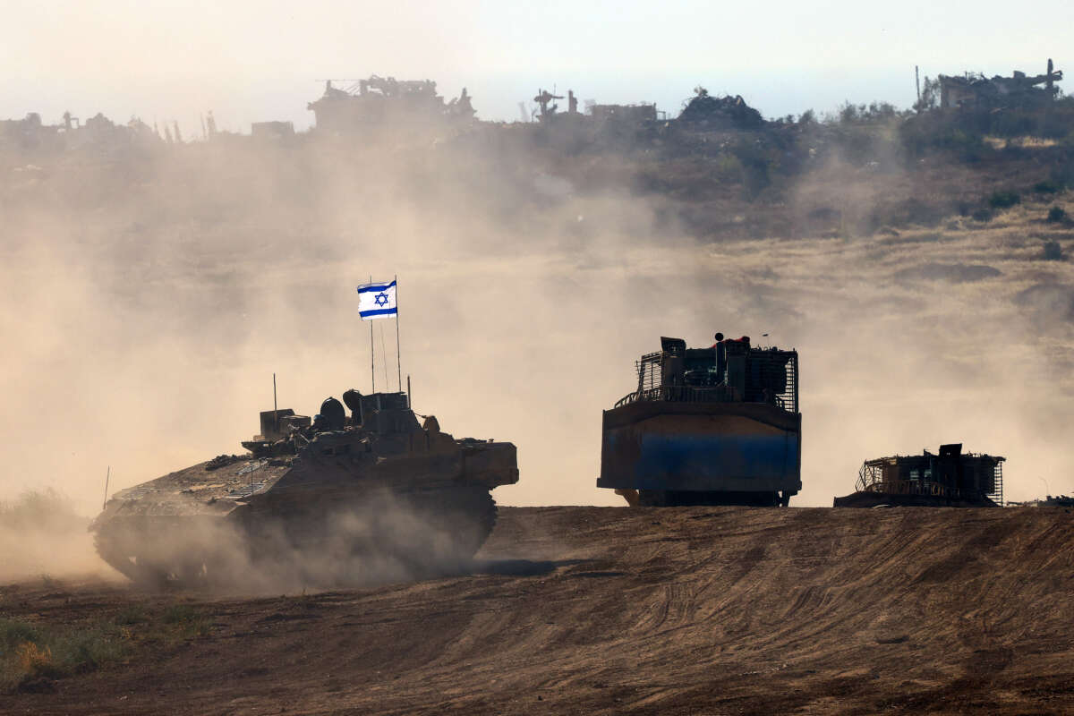 This picture taken from Israel's southern border with the Gaza Strip shows Israeli bulldozers behind an armored vehicle rolling along the border with the Palestinian territory on April 17, 2024.