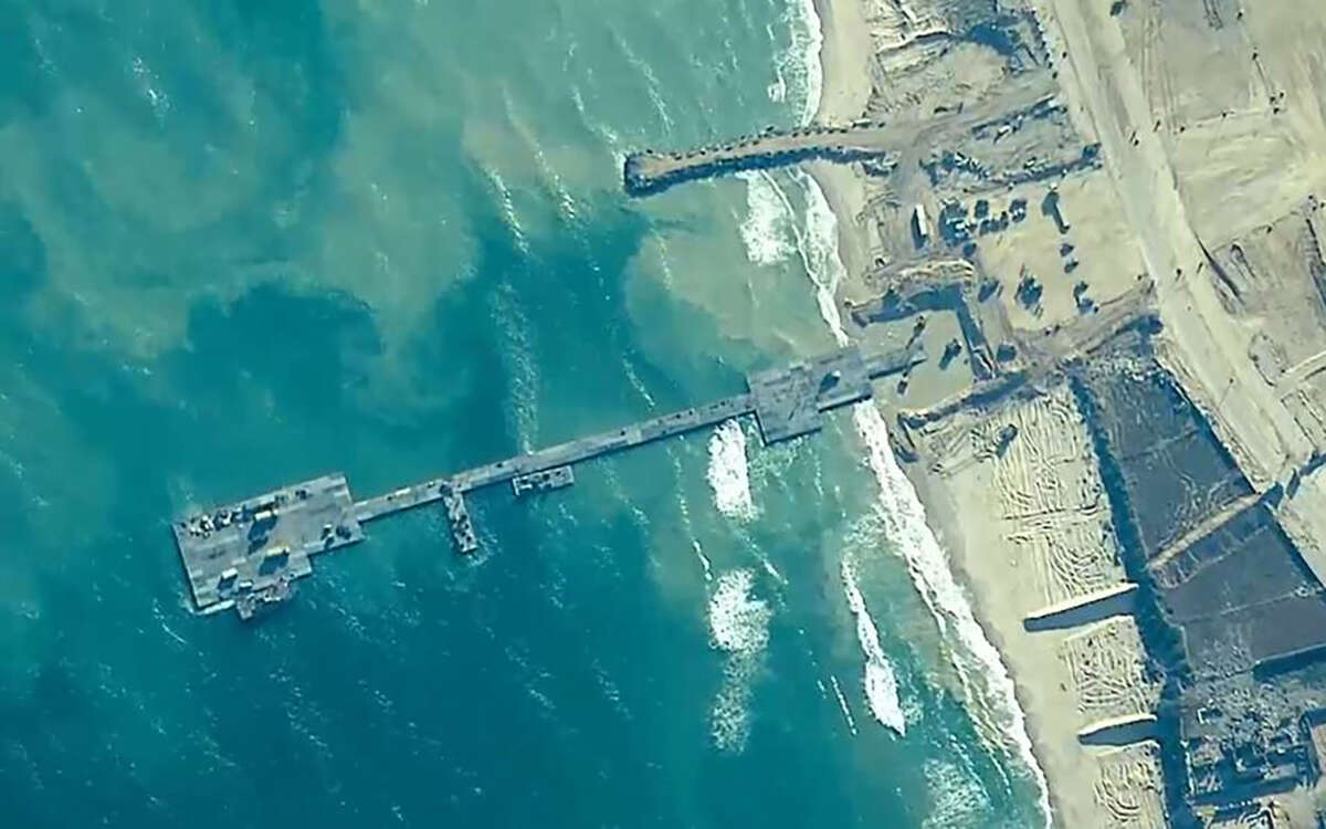 U.S. Army Soldiers assigned to the 7th Transportation Brigade (Expeditionary), U.S. Navy Sailors assigned to Amphibious Construction Battalion 1, and Israel Defense Forces emplace the Trident Pier, May 16, 2024, on the Gaza coast.