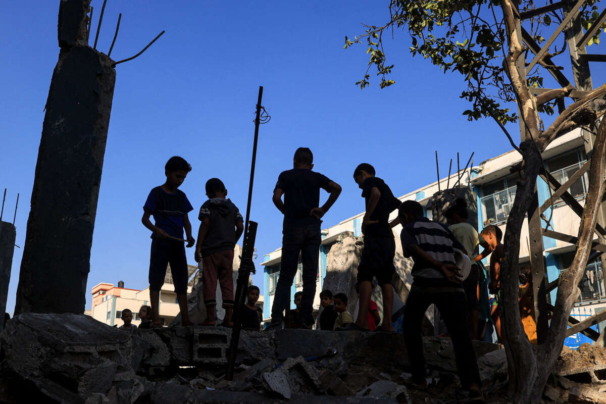 Children check the destruction at a UN-run school after Israeli bombardment in Nuseirat in the central Gaza Strip on July 9, 2024.