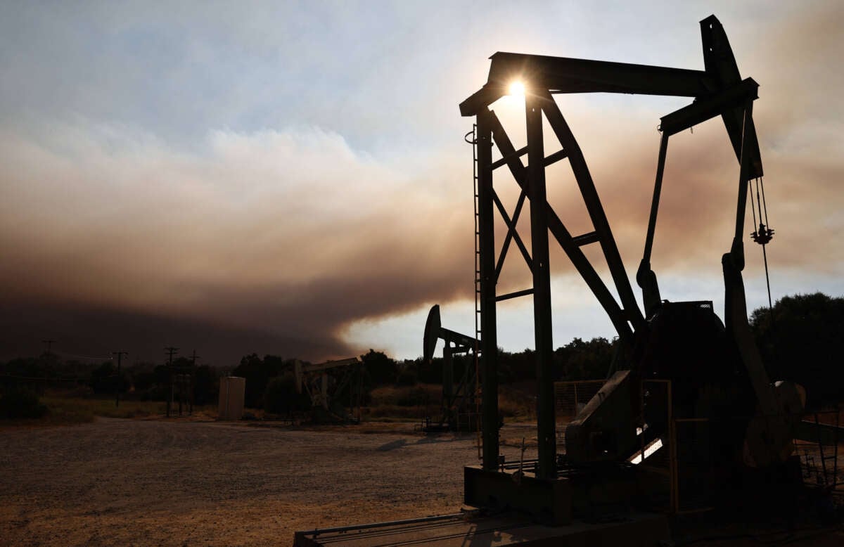 Oil pumpjacks operate as the Lake Fire burns in Los Padres National Forest on July 6, 2024, near Los Olivos, California.