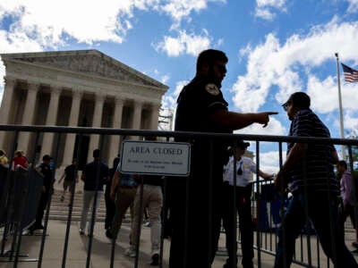 People who are watching the proceedings are escorted past a security gate at the Supreme Court of the United States in Washington, D.C., on July 1, 2024.