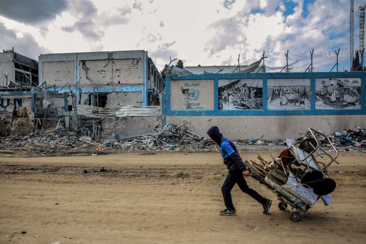A man walks past the damaged Gaza City headquarters of the United Nations Relief and Works Agency for Palestine Refugees (UNRWA) on February 15, 2024. The building has since been leveled.
