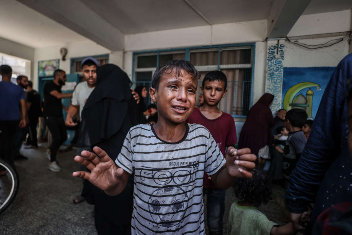 A Palestinian child cries after Israeli fighter jets hit a United Nations Relief and Works Agency for Palestine Refugees in the Near East (UNRWA) school, killing and injuring many in the Nuseirat refugee camp of Deir al-Balah, Gaza, on July 16, 2024.