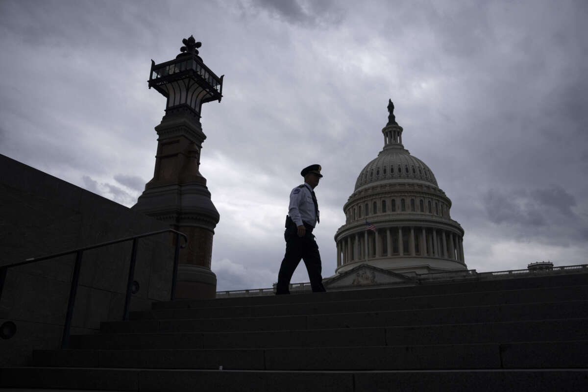 A police officer walks along the East Front of the U.S. Capitol on May 16, 2023, in Washington, D.C.