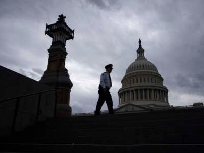 A police officer walks along the East Front of the U.S. Capitol on May 16, 2023, in Washington, D.C.